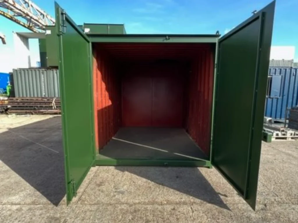 Used green 10ft cut down storage container with double doors open, showing the resprayed interior