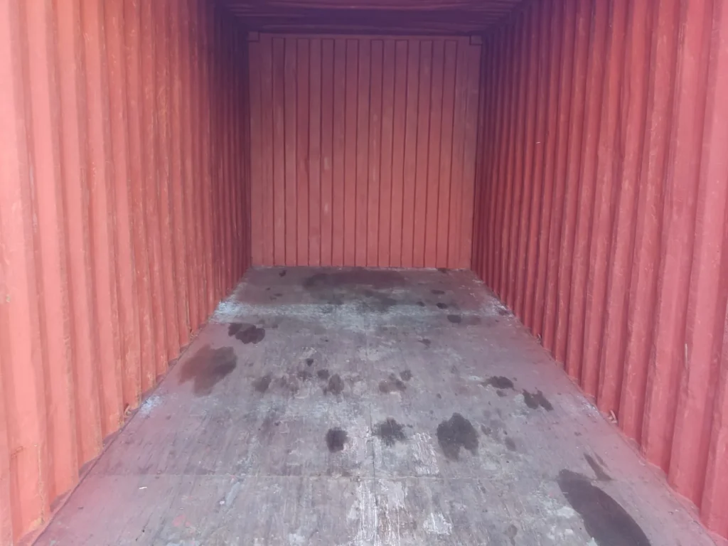 Interior of a used storage container showing the walls and floor